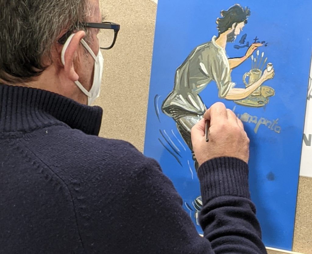 Antonio Villoch paints his panel.